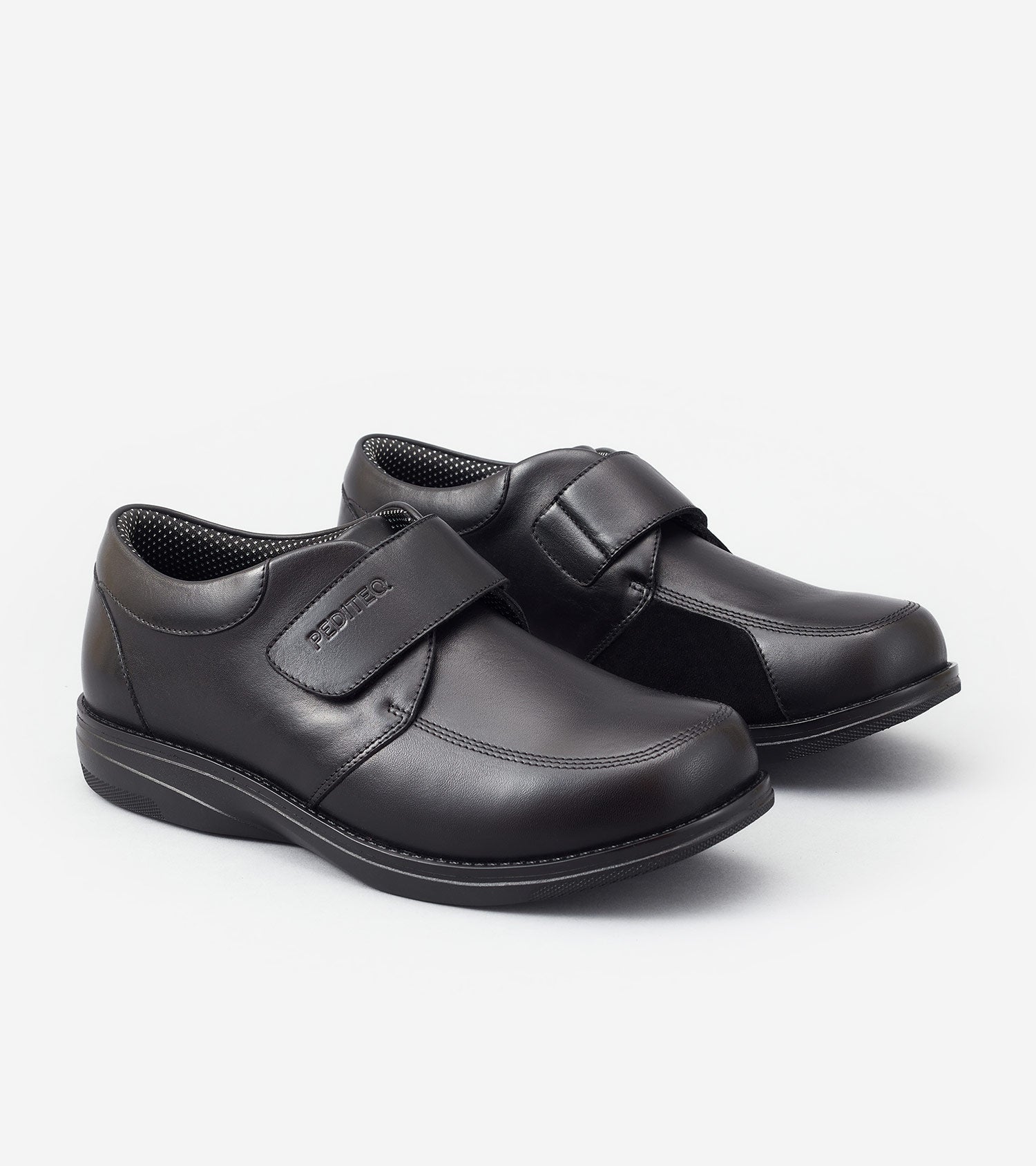 Pair of black shoes with velcro straps on a white background