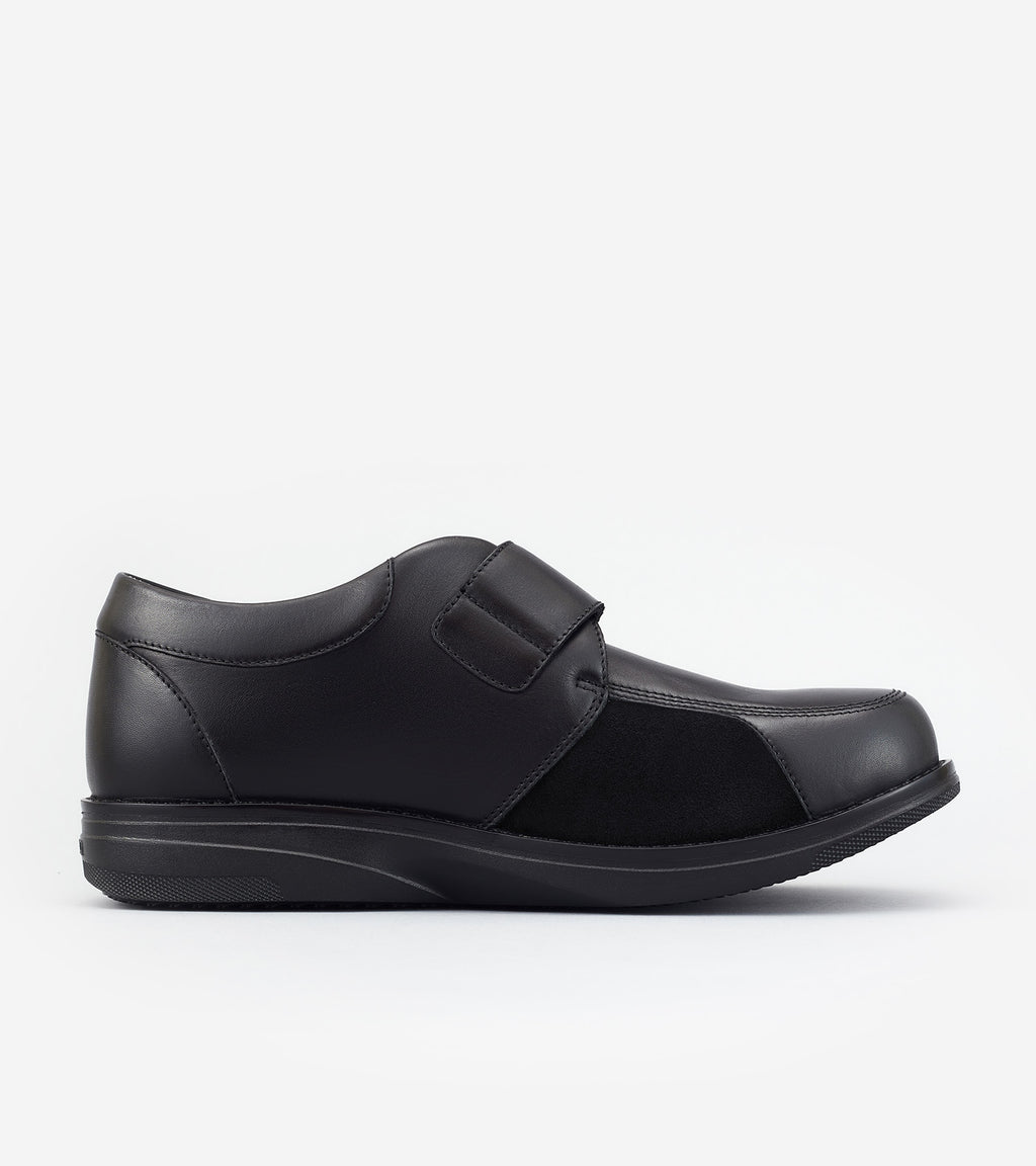 Black leather slip-on shoe on a white background