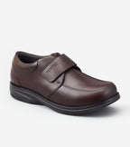 Brown shoe with a velcro strap on a white background