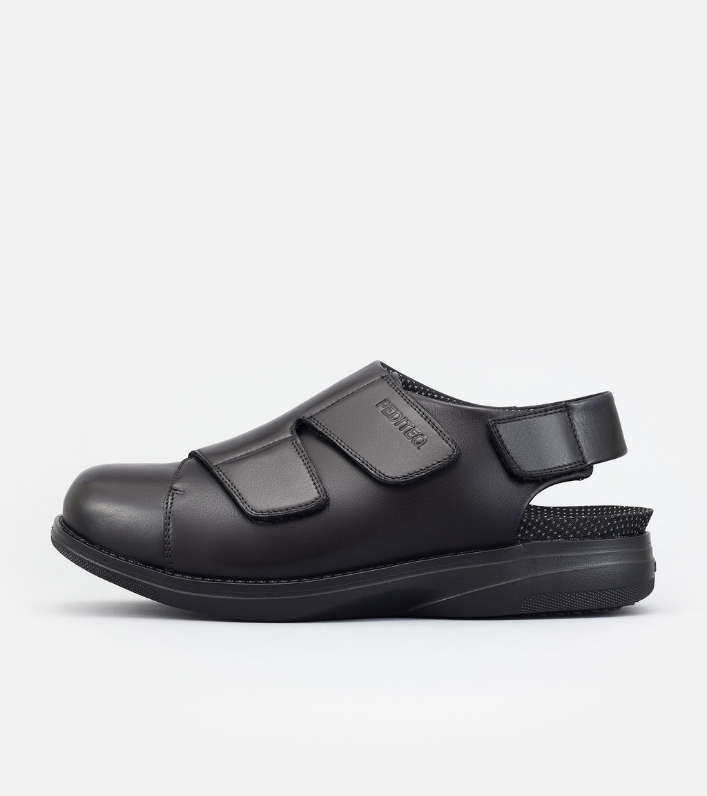 Black shoe with velcro straps on a white background