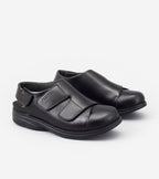 Pair of black shoes with velcro straps on a white background