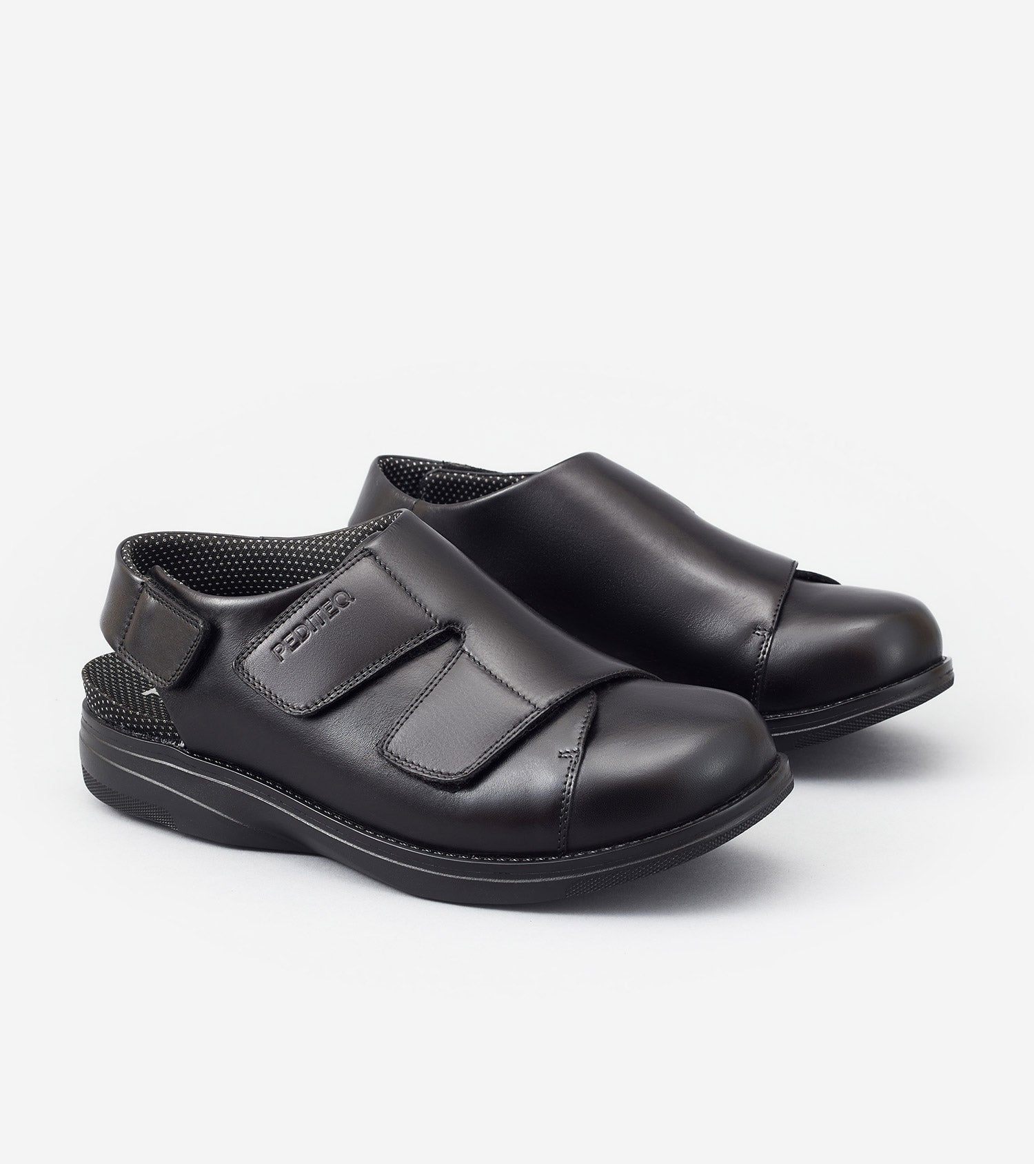 Pair of black shoes with velcro straps on a white background